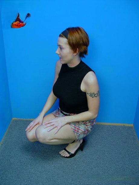 Redheaded chick Alisha Angel gets on her knees to blow a BBC at a gloryhole