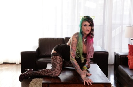 Jackie Moore showing her tattoos naked on the table and her couch