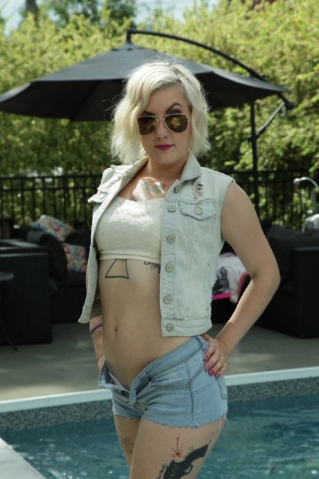 La blonde tatouée Violet Revolver se déshabille au bord de la piscine