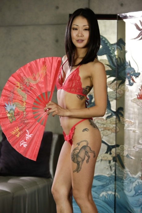 Skinny Asian pornstar Saya Song strips and poses with butt plug up her hole