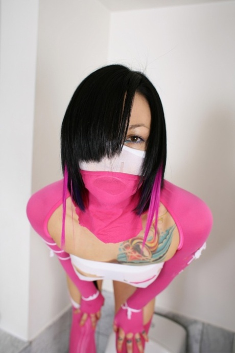 Masked brunette in pink Belladonna dominates over her man in the bathroom