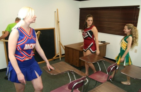 Three naughty cheerleaders show off their blowjob skills in the classroom