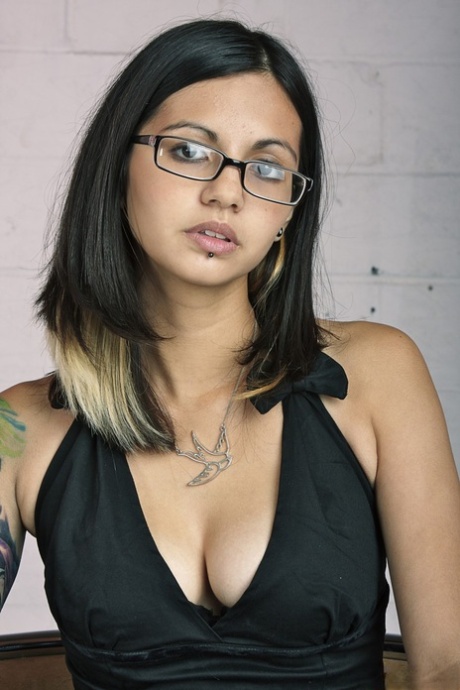 Glasses clad Holly D with big tits drops dress & sheer panties to pose naked