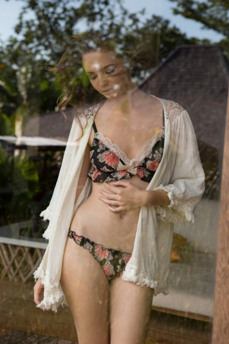 Brunette model Evelyn Sommer takes off her lingerie and shows her medium tits