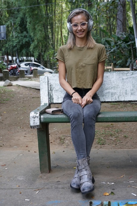 Veronica Leal posing all over her hood in green shirt and tight jeans