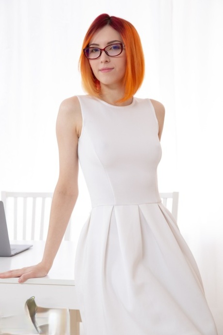 Nerdy redhead Elin Holm drops her white dress before a passionate ass bang
