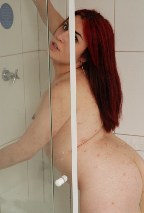 Redheaded shemale in stockings Anita Volgato masturbates in the shower