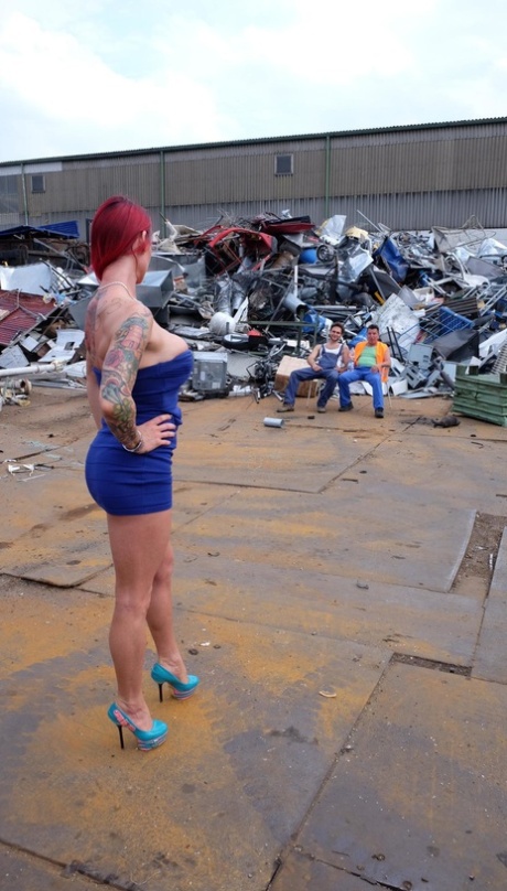 Redhead MILF with tattoos and fake tits gets banged in a junk yard 3some