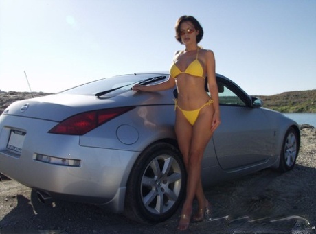 Brunette MILF Crissy Moran unveils her fabulous boobs while washing a car