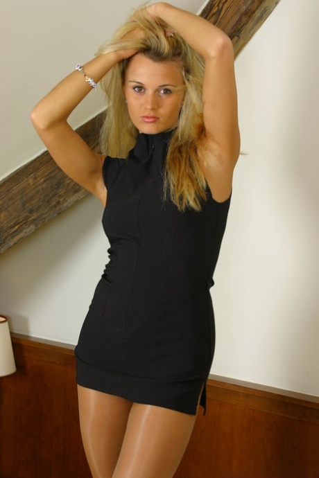 Rachel, blonde sexy, porte des collants sur le lit et aguiche ses jolis seins.