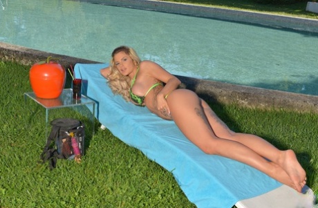 Sexy blonde MILF Candy Sexton flaunts her fake tits & rubs her pussy poolside