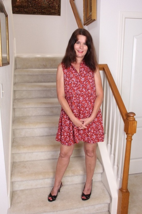 Mature Bridget Calling comes down and stops on the stairs to masturbate