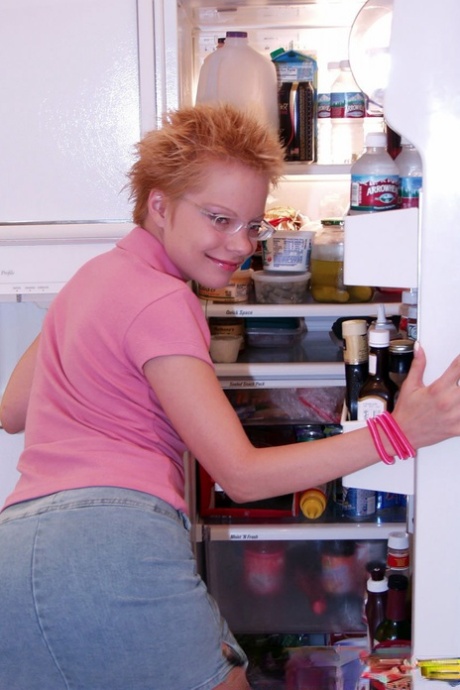 Naughty redhead Emily Davinci goes topless & indulges in a food play solo