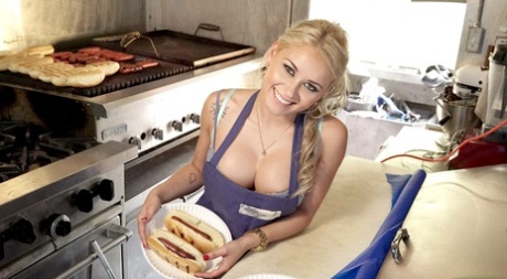 Adorable babe Marsha May shows how to prepare a hot dog while her tits are out