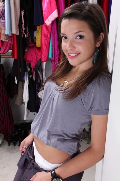 Charming teen Veronica Berry strips in the closet and spreads her pussy