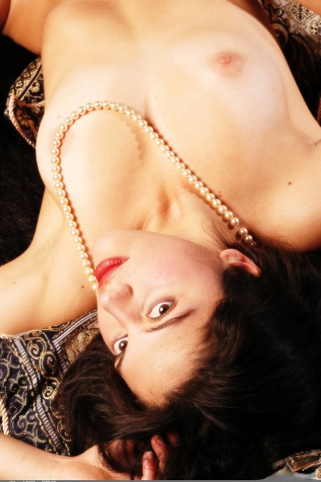 Alluring brunette teen lays her pearls and small tits spread out for all to see