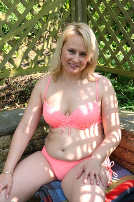 Den modne blondinen Michelle F tar av seg bikinien og erter helt naken utendørs.