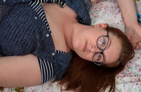 Chubby redheaded geek Breanna reveals her huge breasts and toys her bush