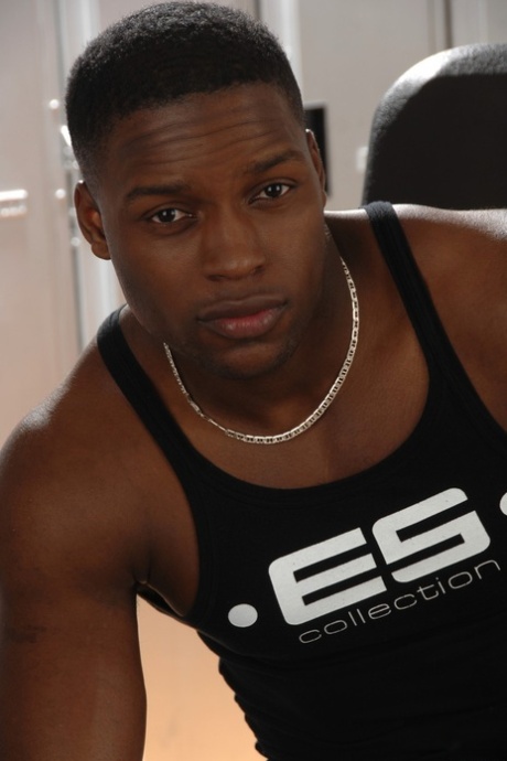 Strong ebony hunk Tyler Price strips at the gym and strokes his shaft