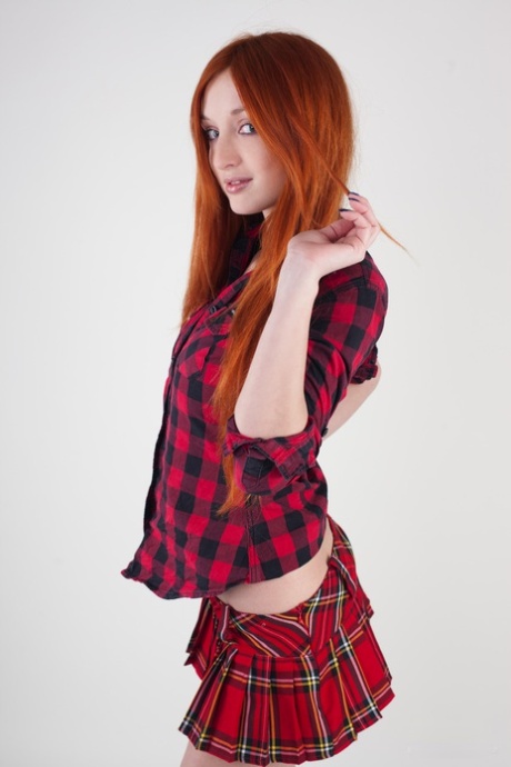 Redheaded schoolgirl Micca shows her big tits and poses nude on a chair