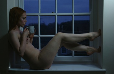 Den rødhårede teenager Ella Hughes driller helt nøgen ved vinduet om natten