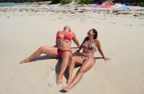 Mature lesbian MILFs pose in their sexy bikinis and show off their boobs