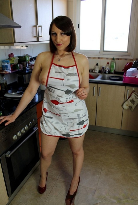 Housewife in an apron Jenny Lety teases with her big tits & ass in the kitchen