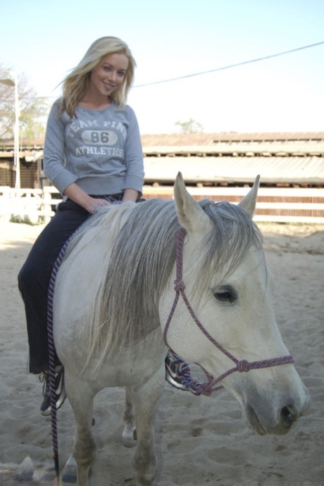 Blonde American MILF Kayden Kross plays with her horse at the ranch