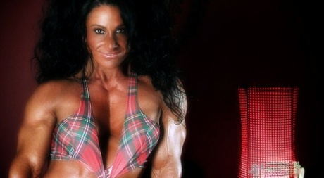 Brunette American bodybuilder Debbie Bramwell flaunts her hot abs and muscles