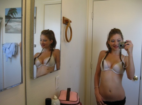 俏皮的业余少女迪克西对着镜子自拍，同时摆出性感姿势