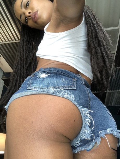 Ebony with dreads Kira Noir unveils her tiny tits and sweet ass in a solo