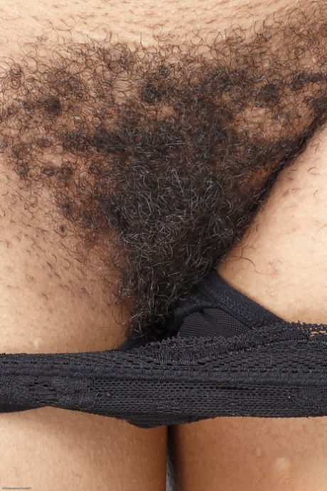 Sexy black babe Cupcake Sinclair spreads her very hairy pussy up close