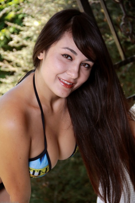 Cute Asian teen Sophia Jade peels off her bikini bottom and rubs her vagina