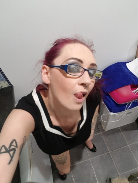 Nerdy amateur redhead Demona Dragon presents her amazing tits and twat