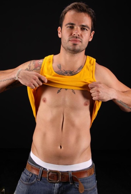 Tattooed gay hunk Carver shows off his athletic naked body & his hard dick