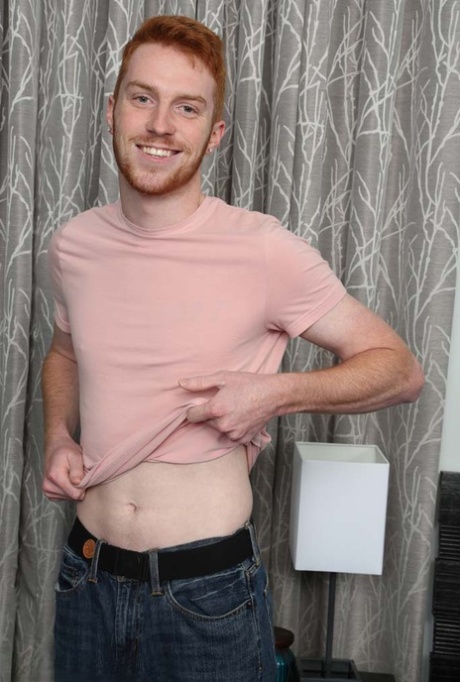 Redheaded gay hottie Sebastian Hunt unveils his inked body and stiff penis