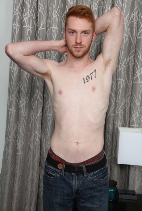 Redheaded gay hottie Sebastian Hunt unveils his inked body and stiff penis