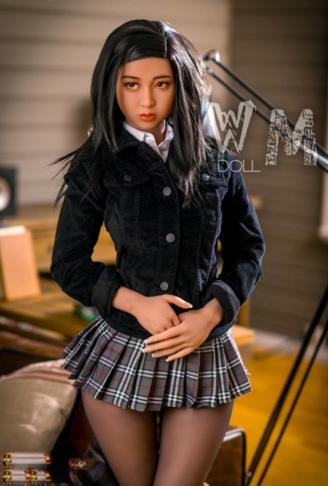 Cute sex doll in a schoolgirl outfit strips to show her gorgeous naked body