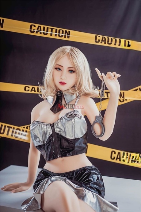 Blonde sex doll with a pistol Mei poses in high heels and a short skirt