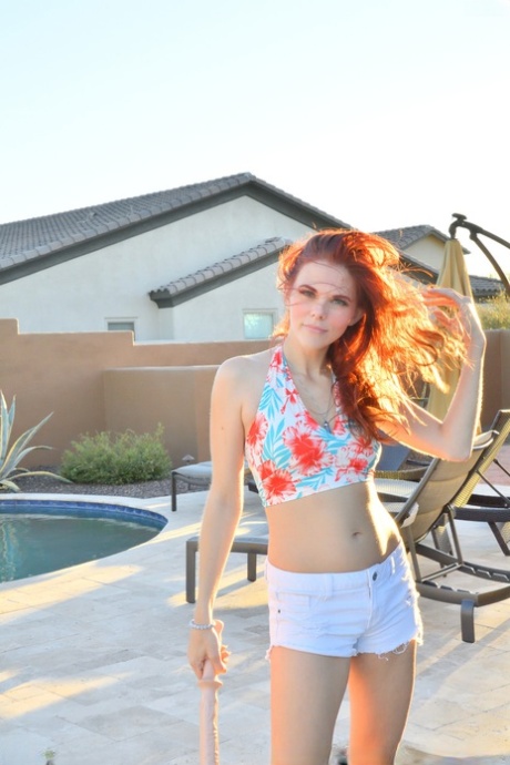 Redheaded MILF Devyn bares her body outdoors & toys herself with a long dildo