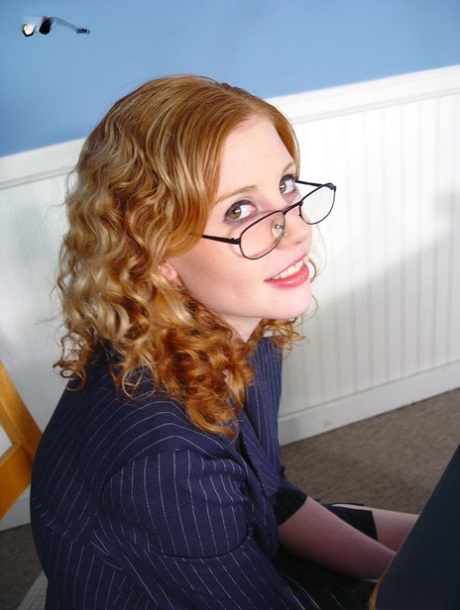 Horny ginger in glasses Cherry Poppens kneels to suck black cock