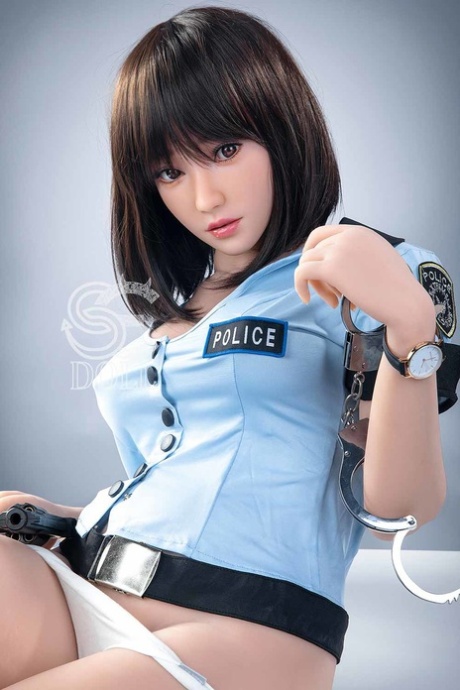 Beautiful Asian sex doll shows her gorgeous breasts in a police uniform