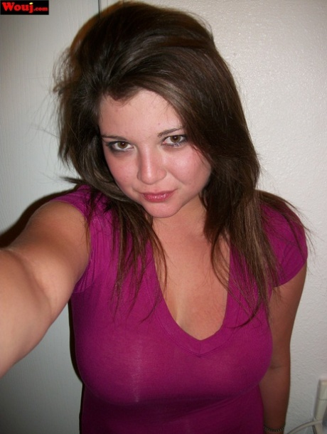 Brunette amateur WouJ flaunts her cleavage wearing a shiny pink dress