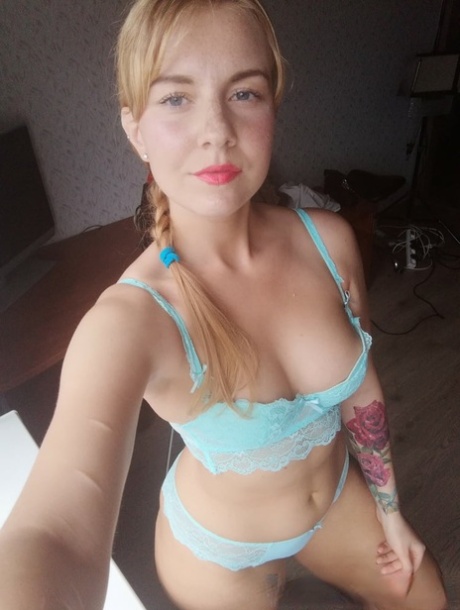 Beautiful amateur doll takes selfies while posing in her turquoise lingerie