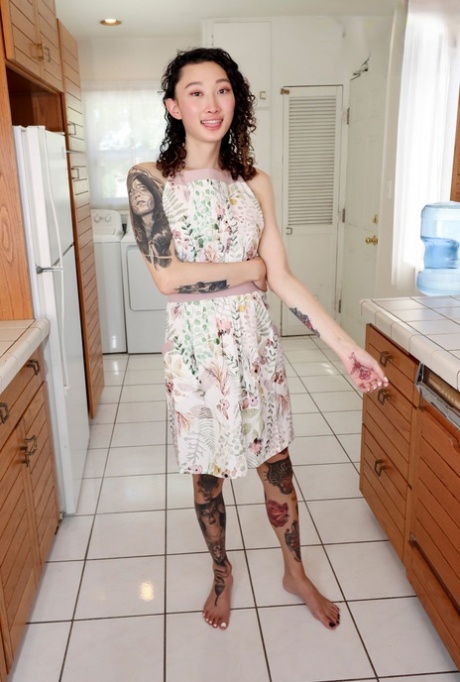 Hot shemale Billie Beaumont unveils her inked body & jerks off in the kitchen