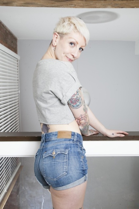 Short-haired British girl Miss Trixx strips & flaunts her big booty