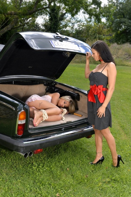 Lesbian Billie Star fools around with her submissive GF in her car trunk