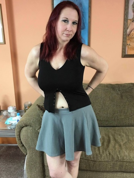 Den kurvede rødhårede Lia Shayde viser sine store bryster og hårde brystvorter, før hun leger