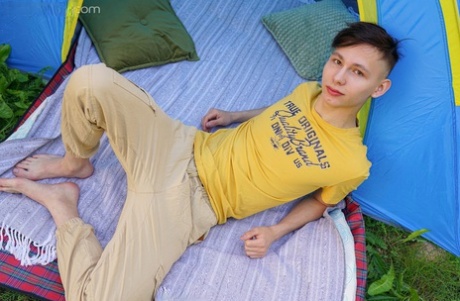 Slim European gay Rimi Morty doffs his clothes slowly & masturbates in a tent