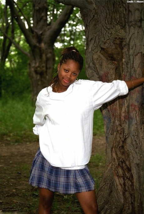 Pretty ebony schoolgirl Lorna shows her tits & her trimmed pussy outdoors